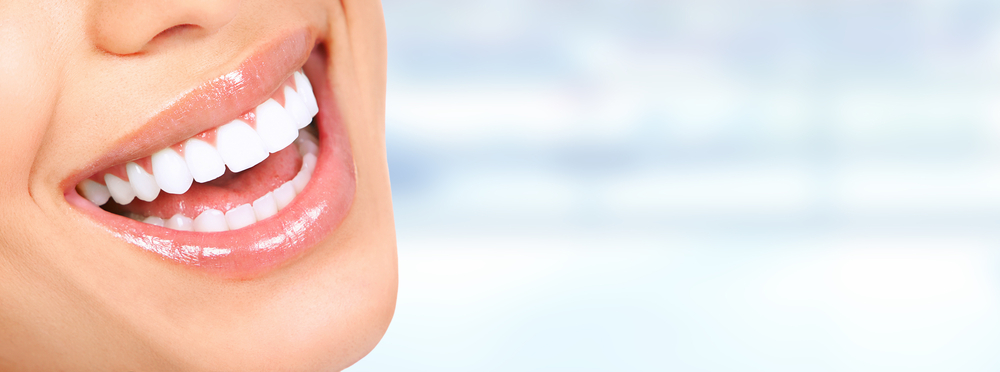 Laughing,Woman,Mouth,With,Great,Teeth,Over,Blue,Background.